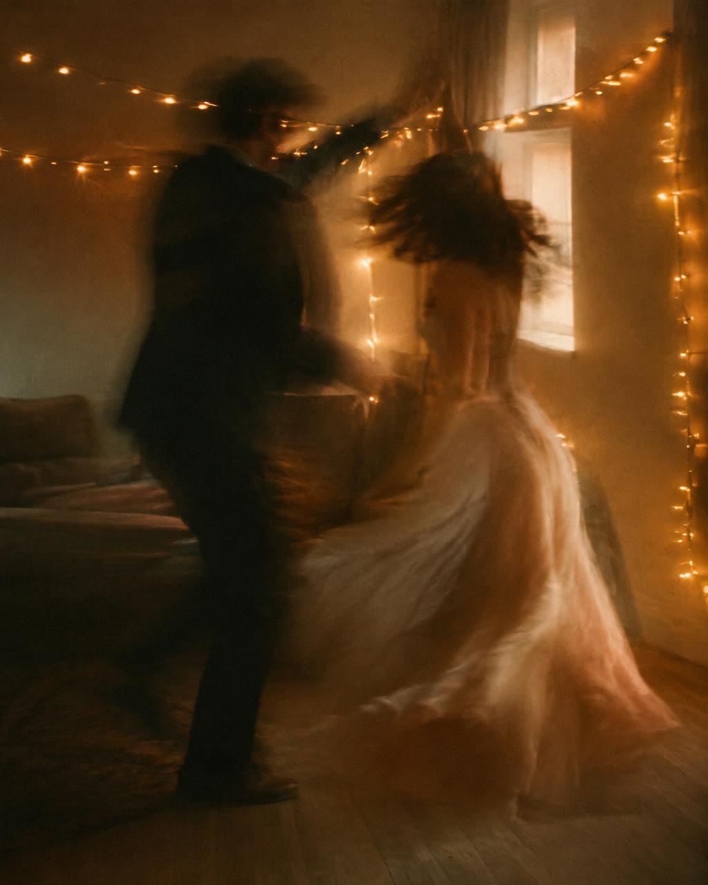 Sample video still: a couple dancing beneath string lights
